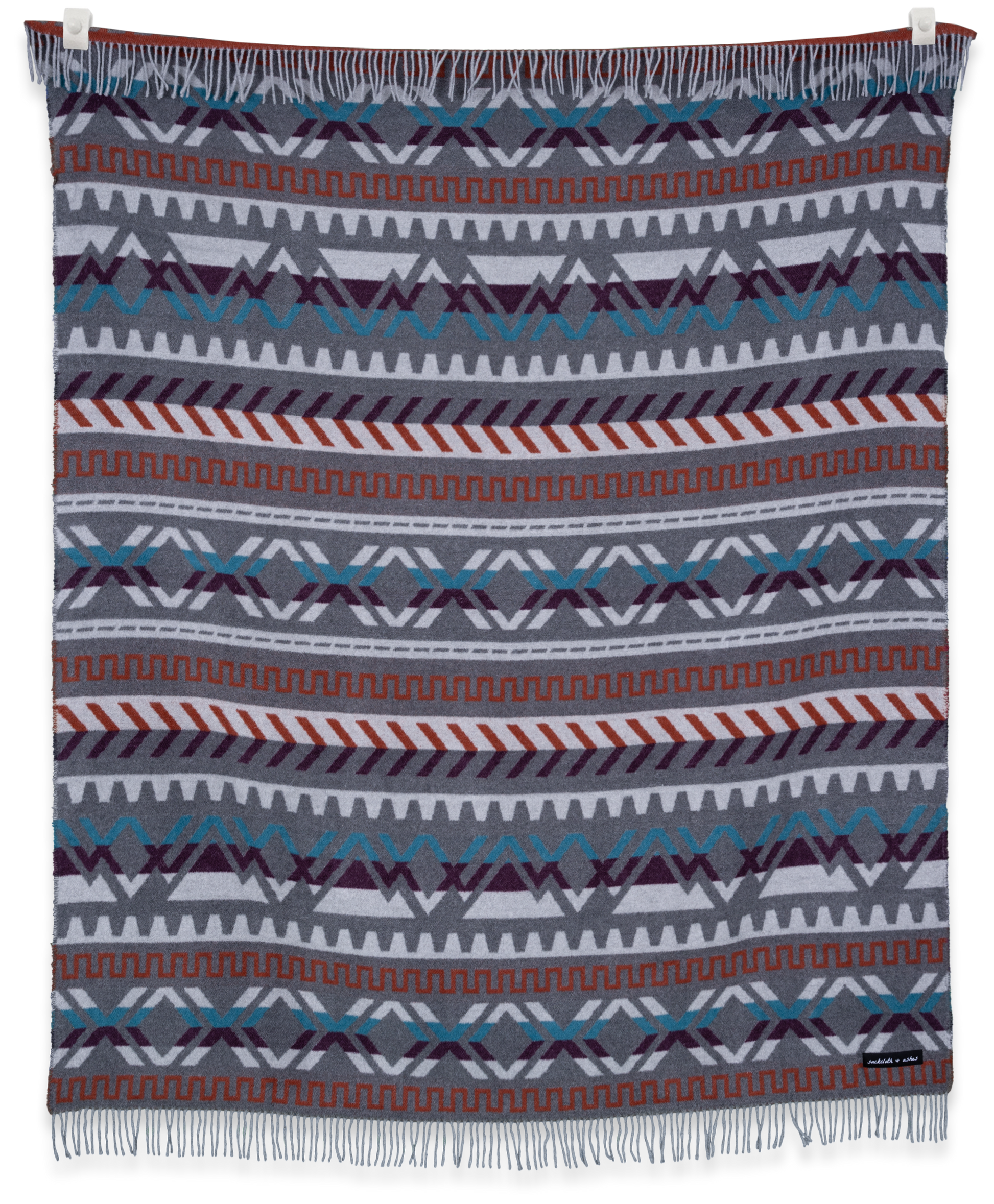 Woven blanket with geometric pattern on a white background
