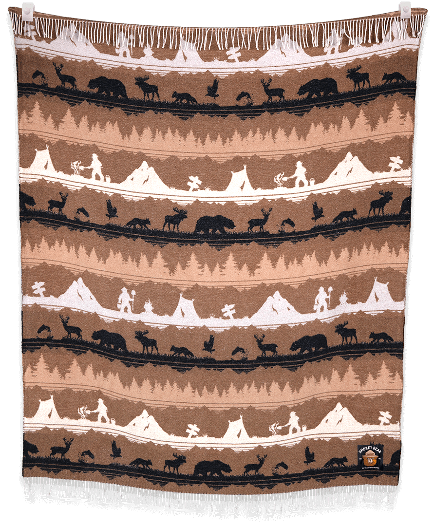Woven blanket with Native American scene pattern on a brown background