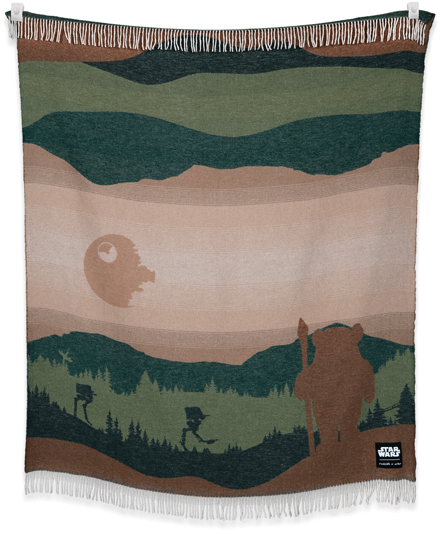 Woven blanket with a landscape design featuring a bear, trees, and a moon.