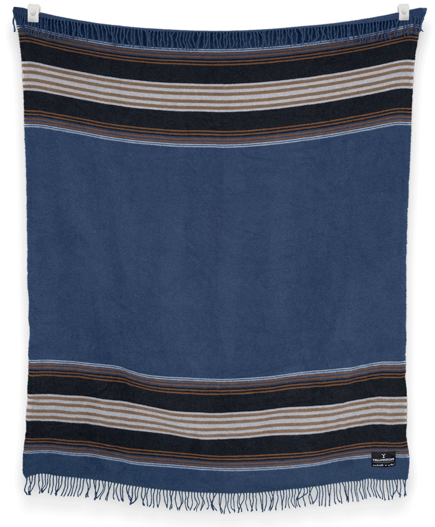Blue towel with striped patterns hanging against a black background