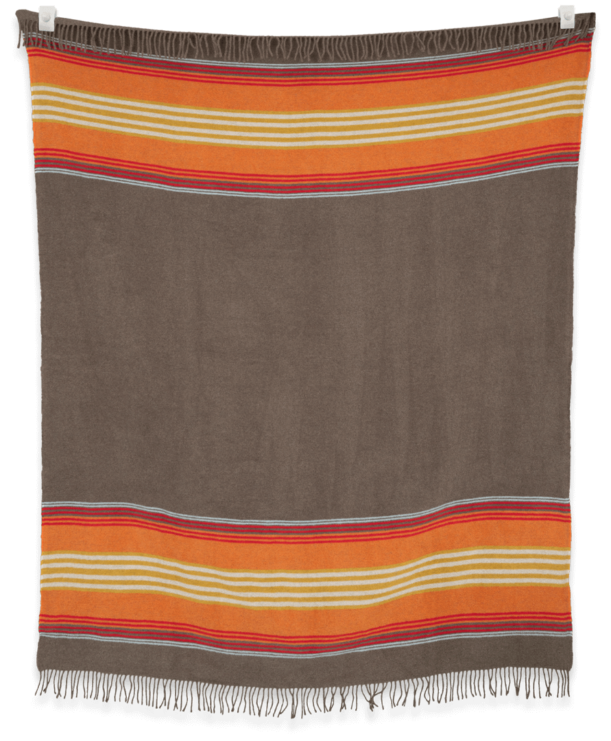 Brown blanket with orange and beige stripes on a black background