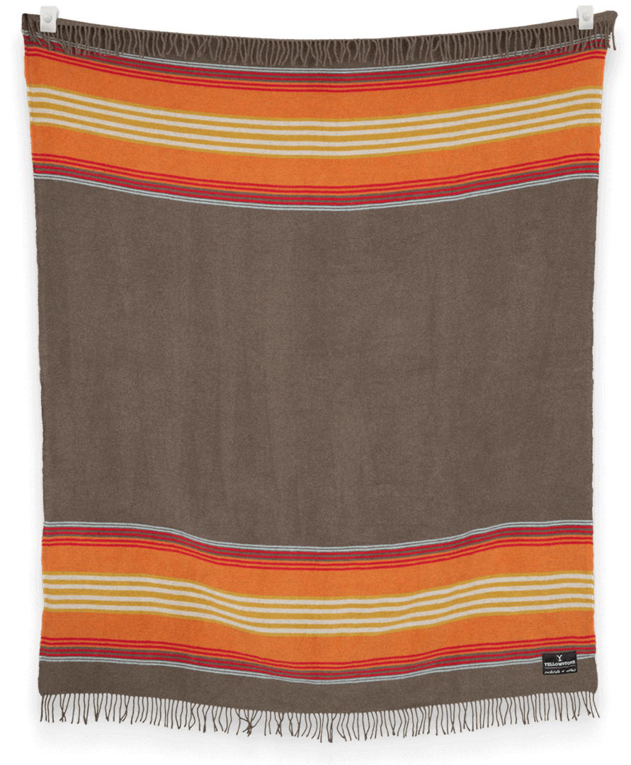 Striped blanket with orange, red, and beige stripes on a brown background