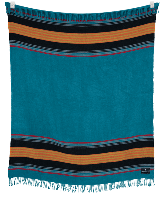 Striped blanket with blue, orange, and black colors on a black background