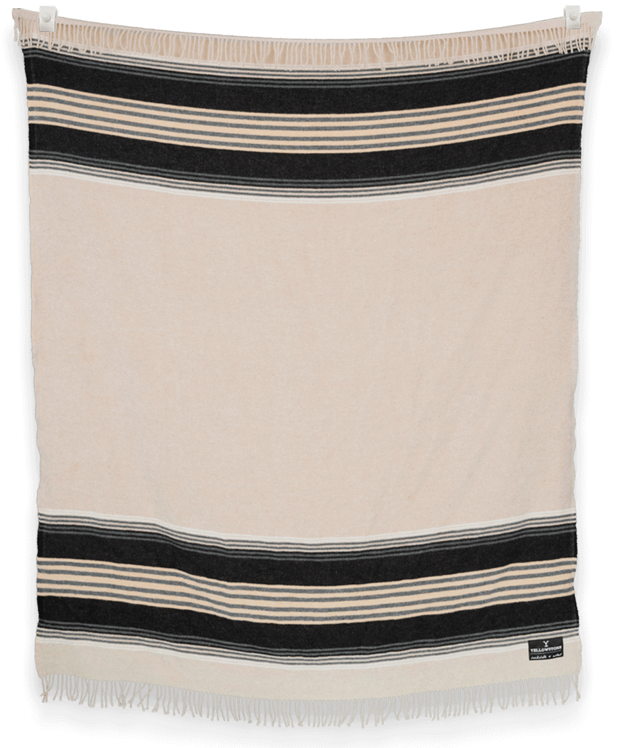 Beige and black striped blanket with fringes on a plain background