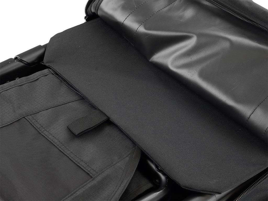 Close-up of a black storage bag  with a zipped compartment open, showing a black chair inside.