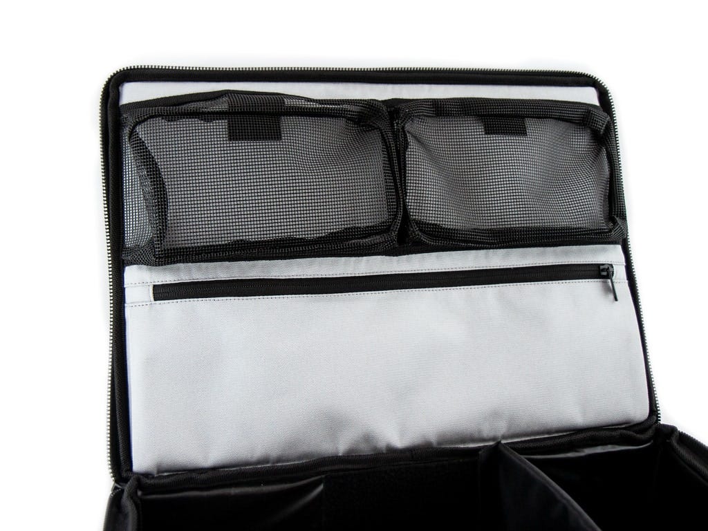 Storage travel organizer bag with mesh and fabric compartments on a white background