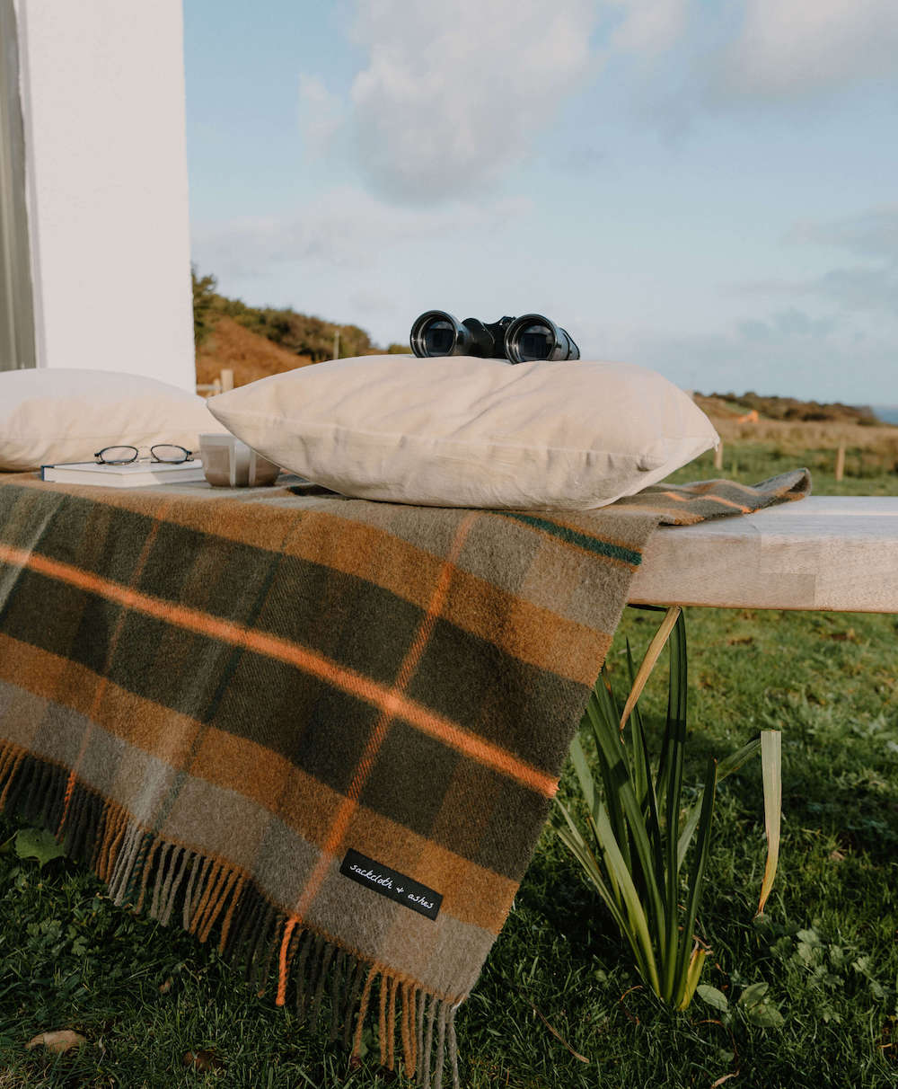 Plaid blanket on a table outdoors with scenic background
