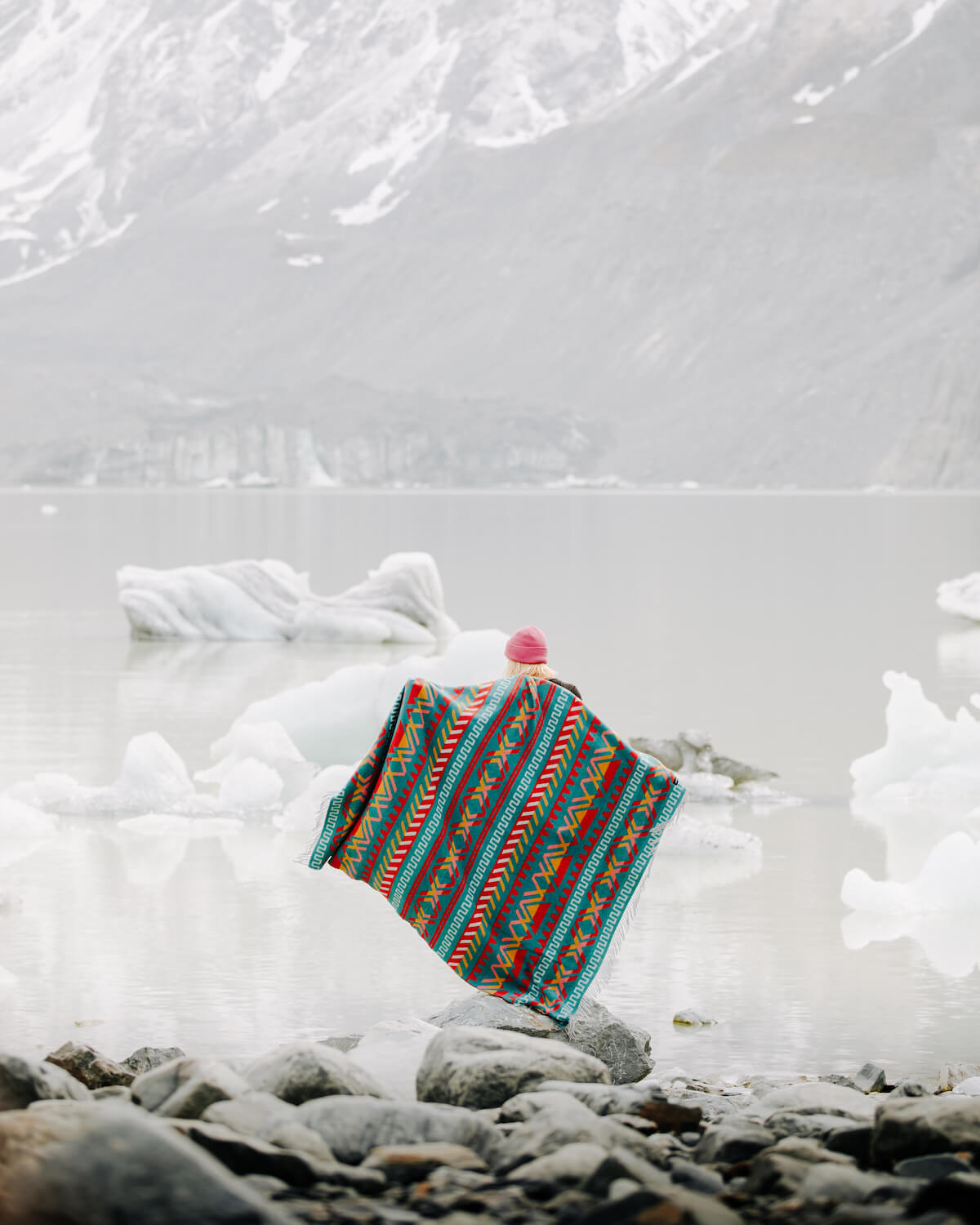 Colorful patterned bag with a pink pom-pom on a snowy landscape