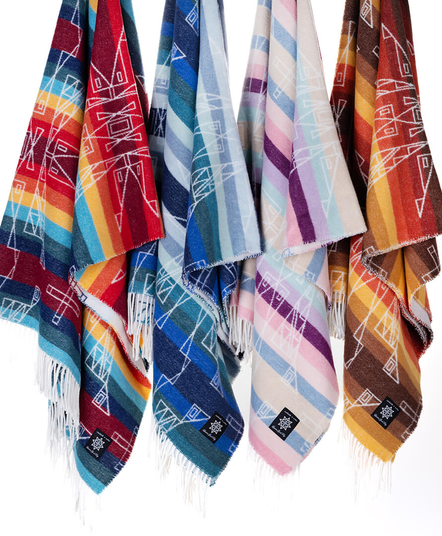 Colorful patterned scarves with fringes on a white background