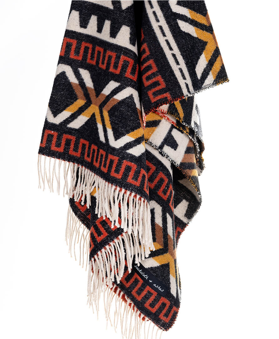 Patterned scarf with fringes on a white background