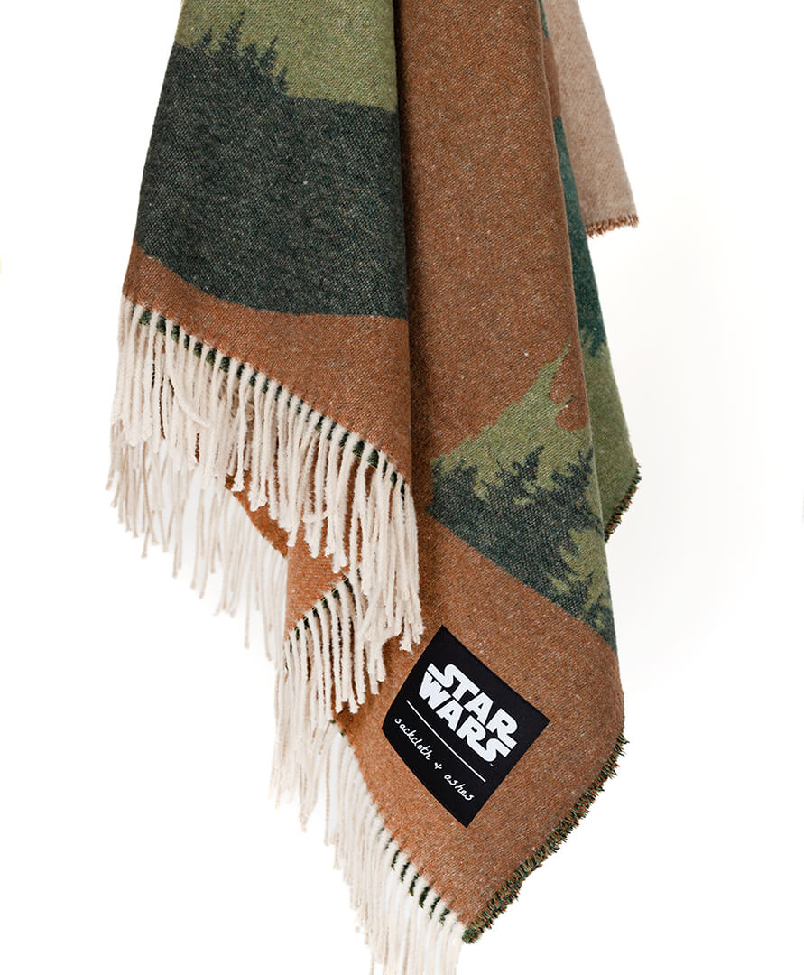 Camouflage-patterned blanket with fringes and a 'Star Wars' label on a white background