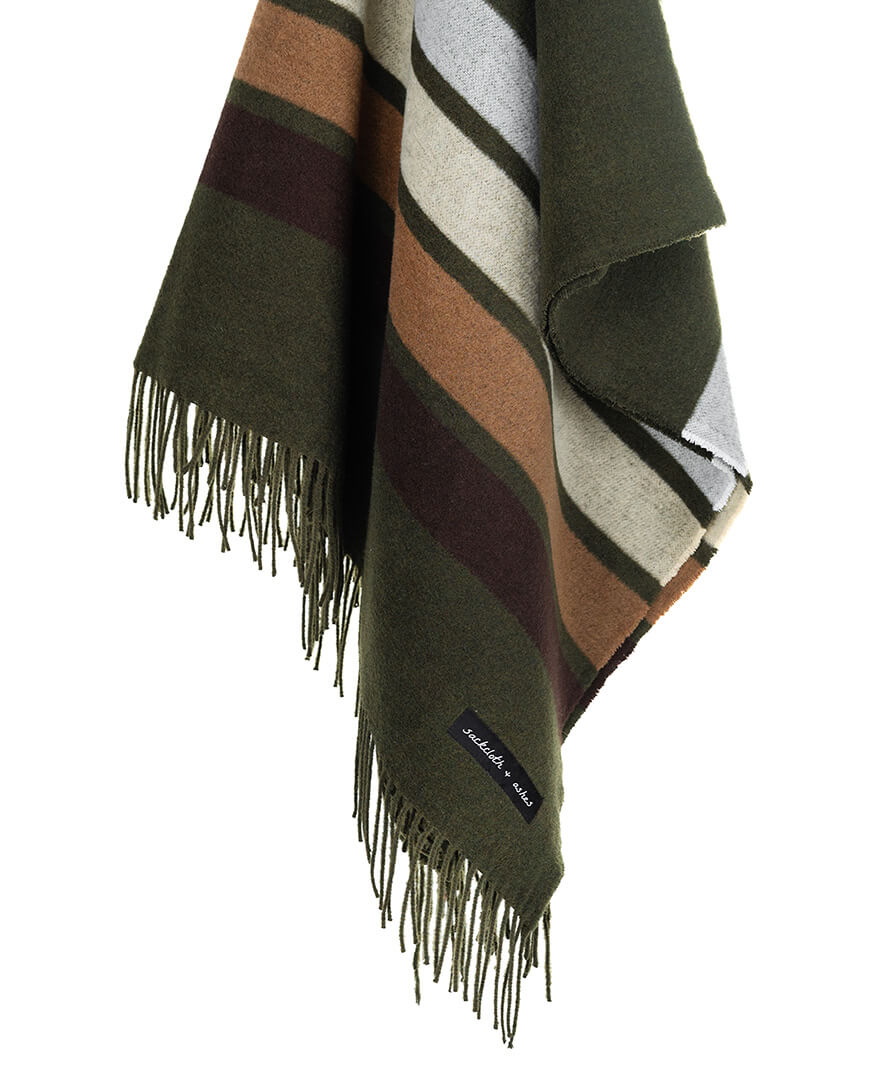Striped blanket with fringes and a brand label on a white background