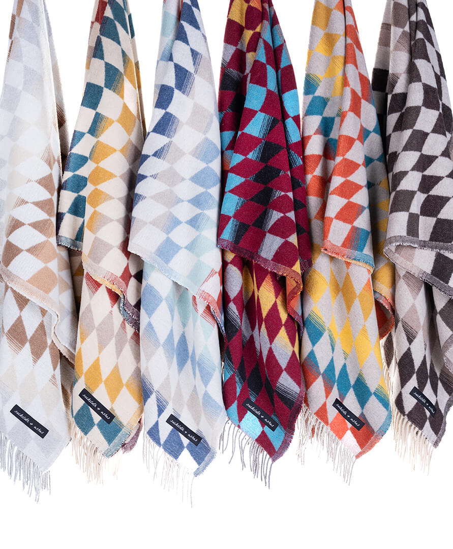 Set of colorful patterned scarves with brand labels on a white background