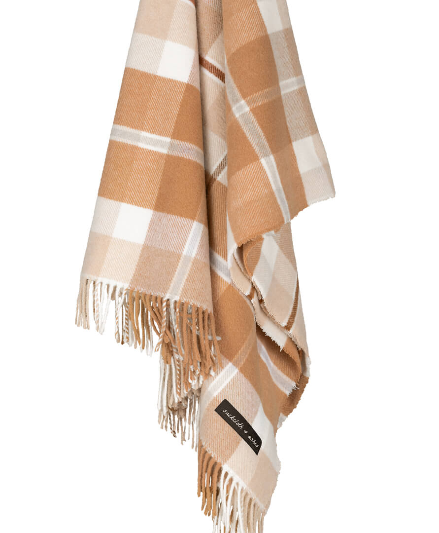 Plaid blanket with fringes on a white background