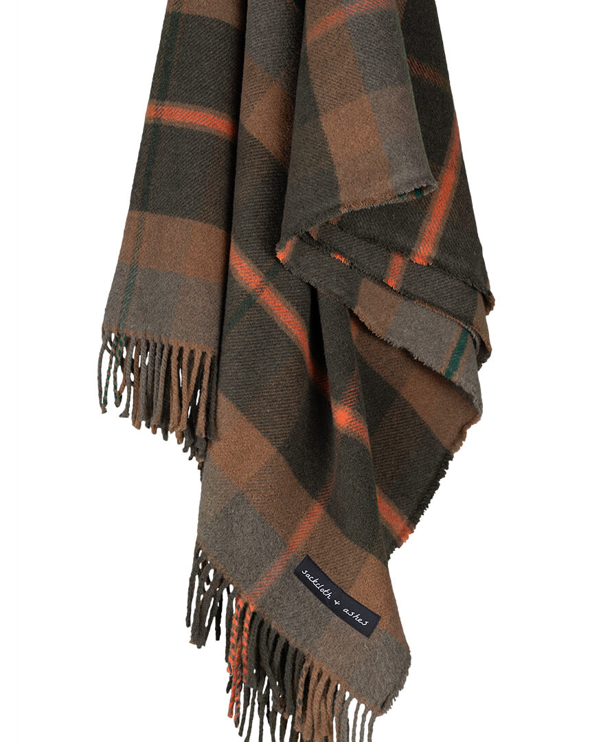 Plaid blanket with fringes on a white background
