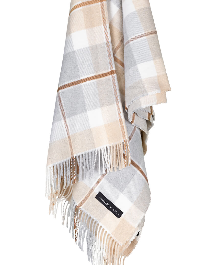 Plaid blanket with fringes on a white background