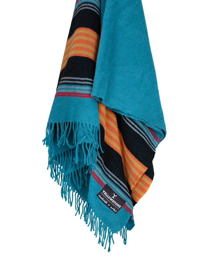 Colorful striped blanket with fringes on a black background