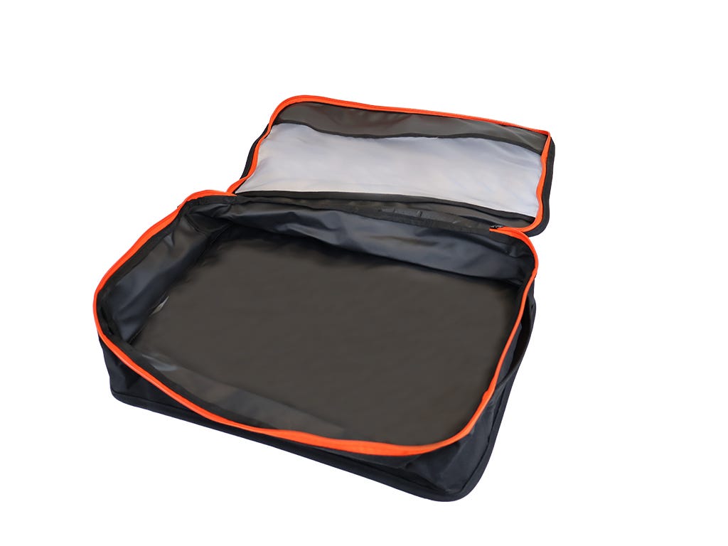 Black travel bag with orange trim on a white background