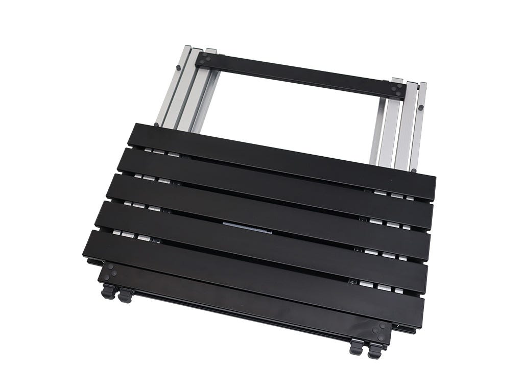 Black folding stool with metal frame on a white background