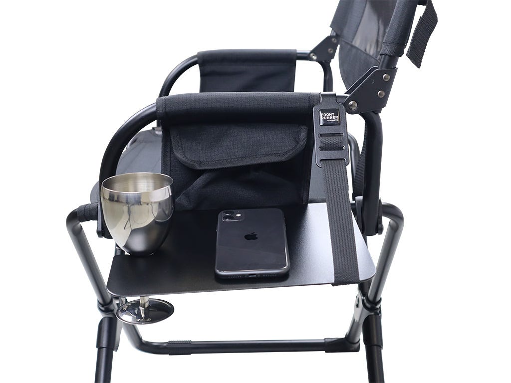 Black director's chair with cup holder, phone, and tablet on a white background